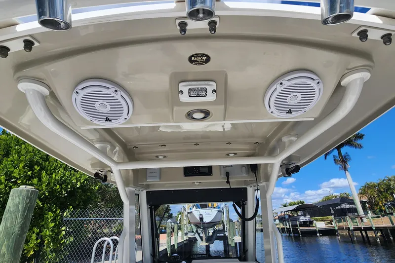 Slide: The Image of 2017 Everglades 255 Center Console boat interior with speakers and rod holders. - 51