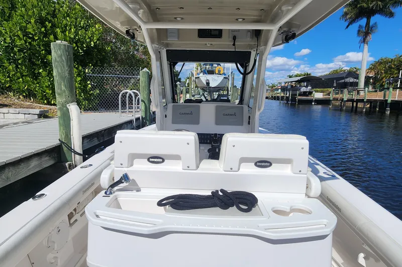 Slide: The Image of 2017 Everglades 255 Center Console boat docked by a scenic canal. - 52