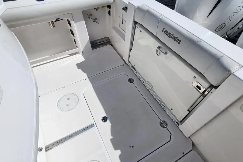Slide: The Image of 2017 Everglades 255 Center Console boat interior, featuring storage compartments and clean deck design. - 55