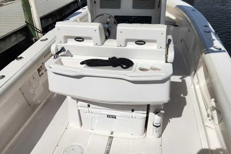 Slide: The Image of 2017 Everglades 255 Center Console boat interior with helm, storage, and Yeti cooler. - 56