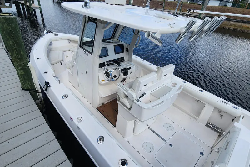 Slide: The Image of 2017 Everglades 255 Center Console boat docked, featuring spacious seating and modern controls. - 6