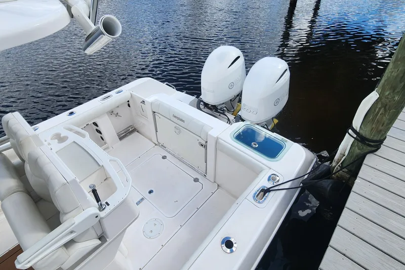 Slide: The Image of 2017 Everglades 255 Center Console boat docked with twin engines. - 8