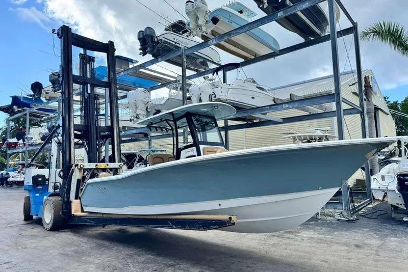 The Image of 2020 Sea Hunt Gamefish 27 boat on forklift at marina storage facility. - 0