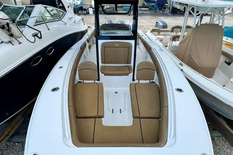 Slide: The Image of 2020 Sea Hunt Gamefish 27 Forward Seating boat with tan cushions, docked among other boats. - 12