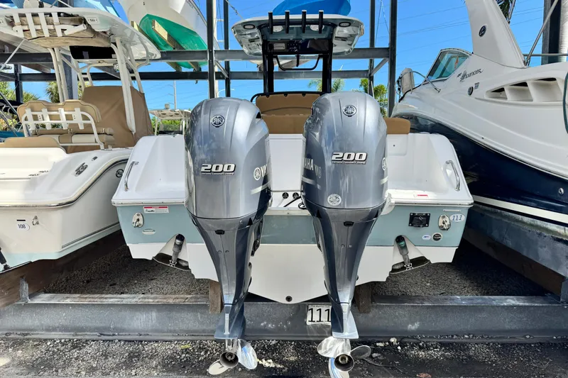 Slide: The Image of 2020 Sea Hunt Gamefish 27 with twin Yamaha 200 engines, docked in a marina. - 3