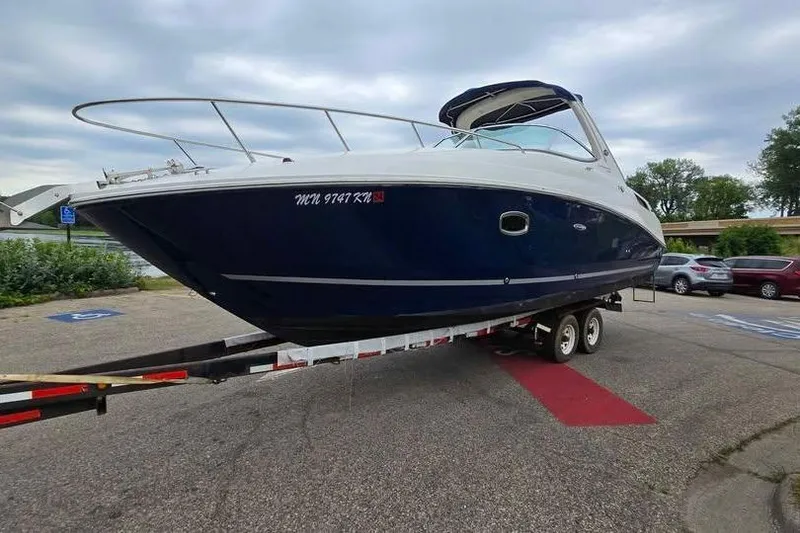 The Image of 2009 Sea Ray 270 Sundancer boat on trailer in parking lot. - 0