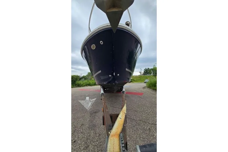 Slide: The Image of 2009 Sea Ray 270 Sundancer boat on trailer, viewed from front, outdoors. - 12