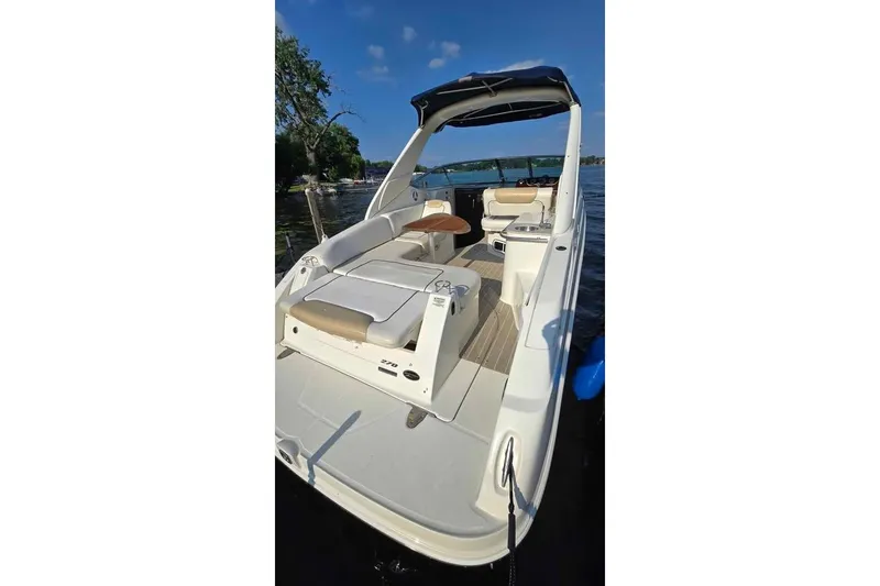 Slide: The Image of 2009 Sea Ray 270 Sundancer boat with spacious deck and seating on a sunny day. - 13