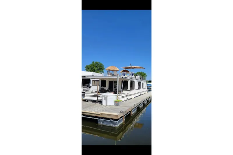 Slide: The Image of Houseboat docked on a sunny day, Catamaran Cruisers 48, year 2000. - 5