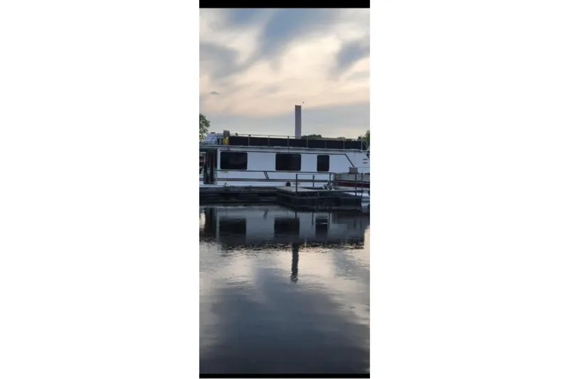 Slide: The Image of 2000 Catamaran Cruisers 48 houseboat docked on calm water at sunset. - 9