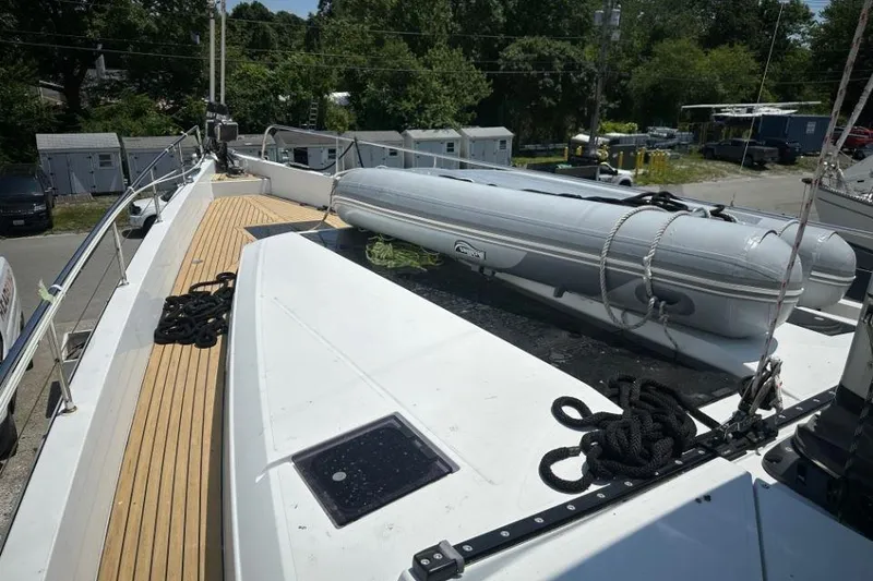 Slide: The Image of 2019 Moody 54 DS yacht deck with inflatable boat and ropes. - 11