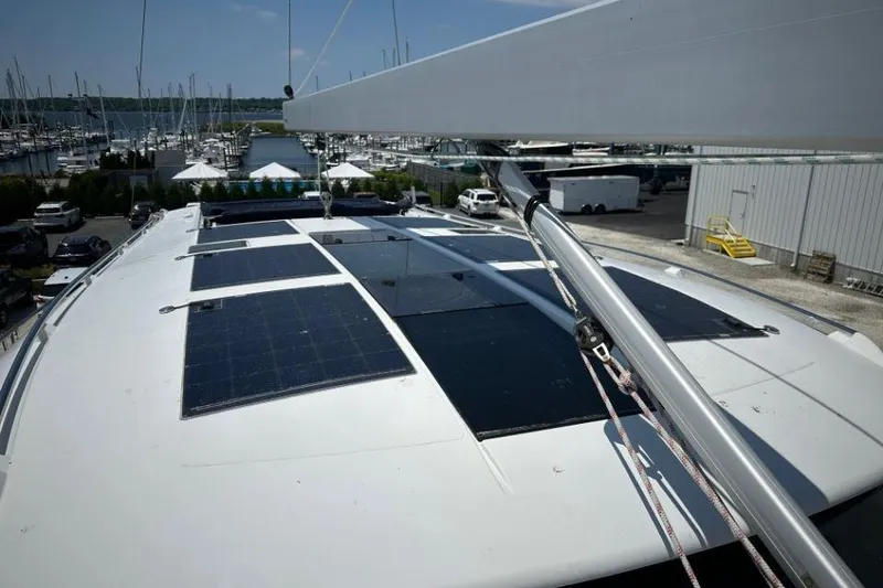 Slide: The Image of 2019 Moody 54 DS yacht with solar panels on deck, docked at marina. - 15