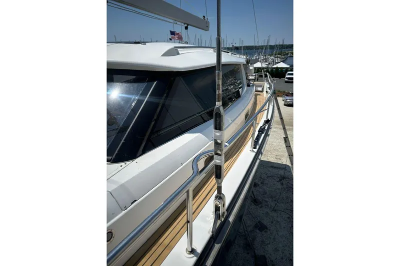 Slide: The Image of 2019 Moody 54 DS yacht docked, showcasing sleek design and polished railings. - 16