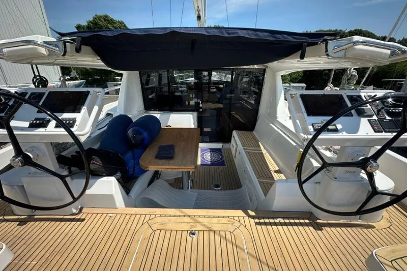 Slide: The Image of Cockpit of 2019 Moody 54 DS yacht with dual steering wheels and teak flooring. - 18