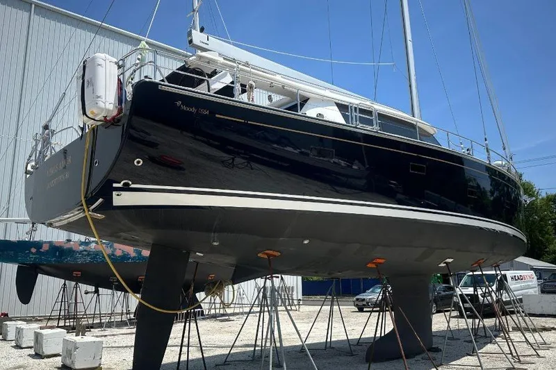 Slide: The Image of 2019 Moody 54 DS sailboat on stands in a boatyard, side view. - 2