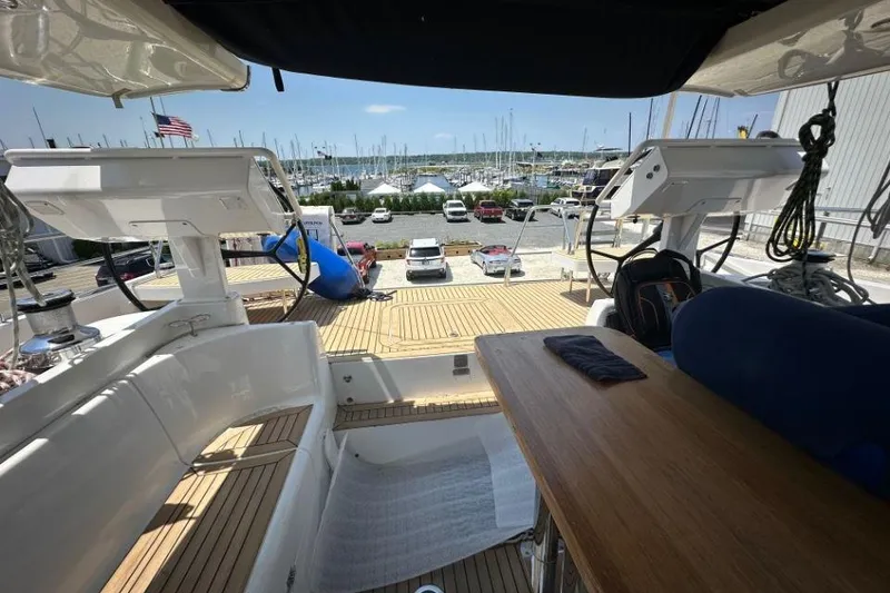Slide: The Image of Luxurious 2019 Moody 54 DS yacht interior with marina view and wooden deck. - 22