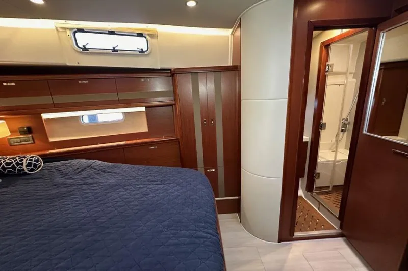 Slide: The Image of Luxurious interior of 2019 Moody 54 DS yacht with elegant wood finish and cozy bedroom. - 29