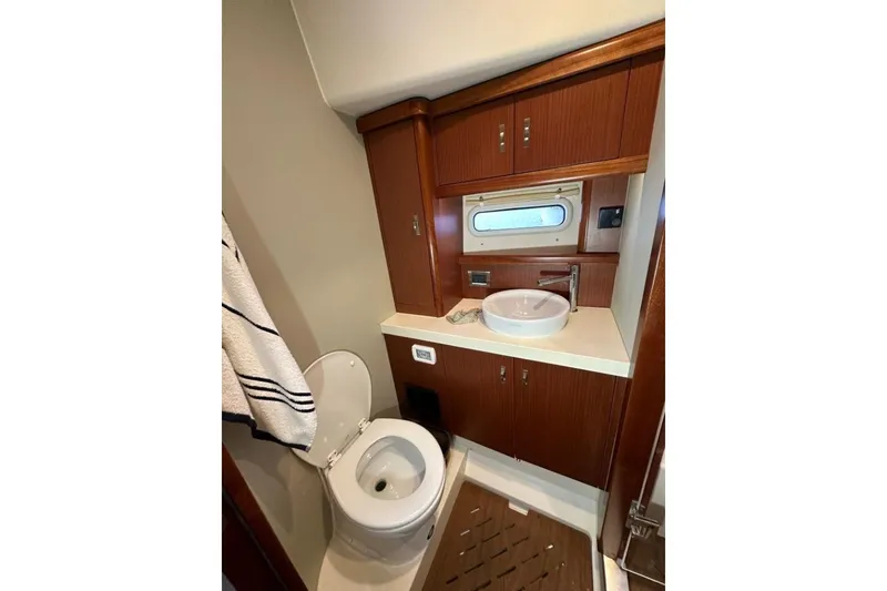 Slide: The Image of Luxurious 2019 Moody 54 DS yacht bathroom with wood cabinetry and modern fixtures. - 31