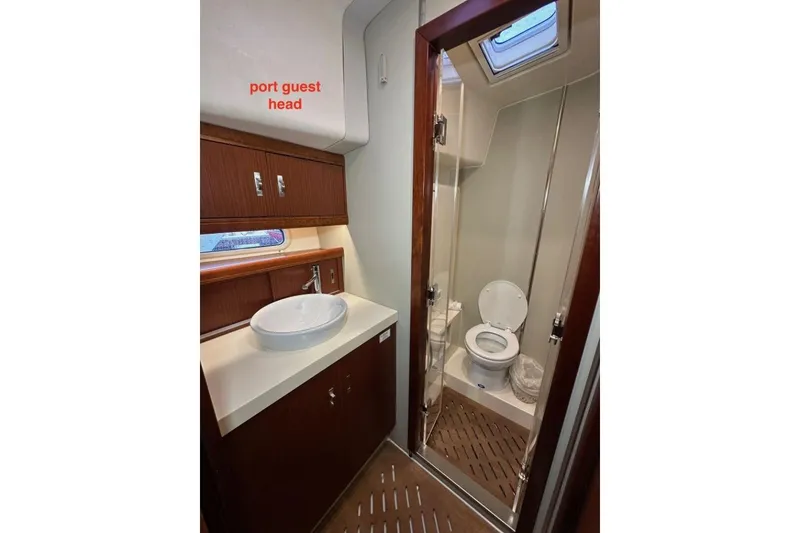 Slide: The Image of Port guest head in 2019 Moody 54 DS yacht, featuring sink and toilet. - 34