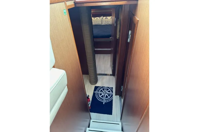 Slide: The Image of Interior view of 2019 Moody 54 DS yacht cabin with nautical-themed decor. - 38