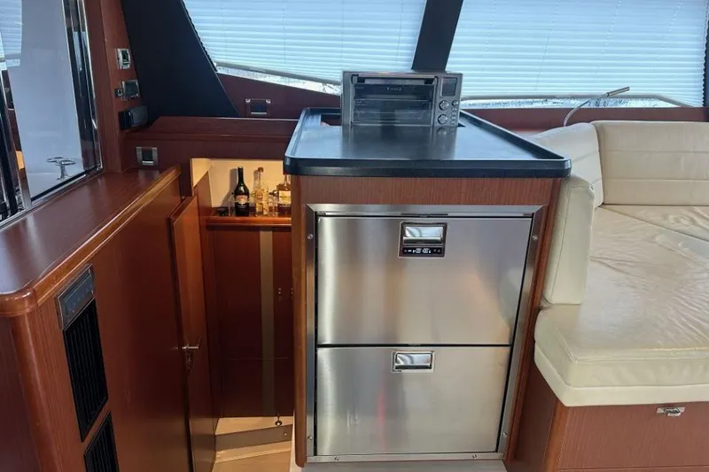 Slide: The Image of Luxurious 2019 Moody 54 DS yacht interior with modern kitchen and seating area. - 39