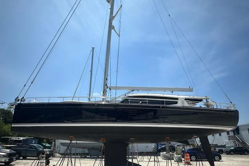 Slide: The Image of 2019 Moody 54 DS yacht on stands, displayed outdoors under clear blue sky. - 4
