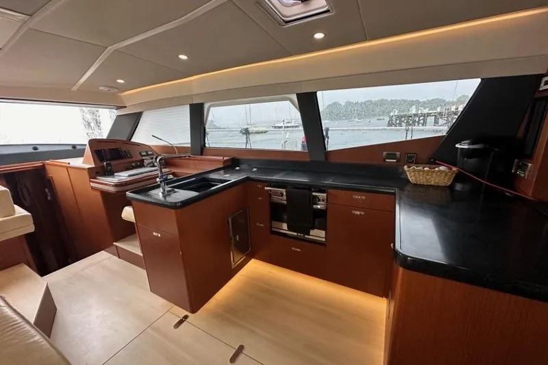 Slide: The Image of Luxurious 2019 Moody 54 DS yacht interior with modern kitchen and scenic window view. - 41