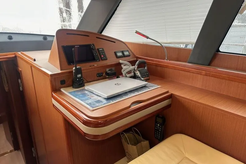 Slide: The Image of Luxurious 2019 Moody 54 DS yacht interior with navigation equipment and wooden finish. - 44