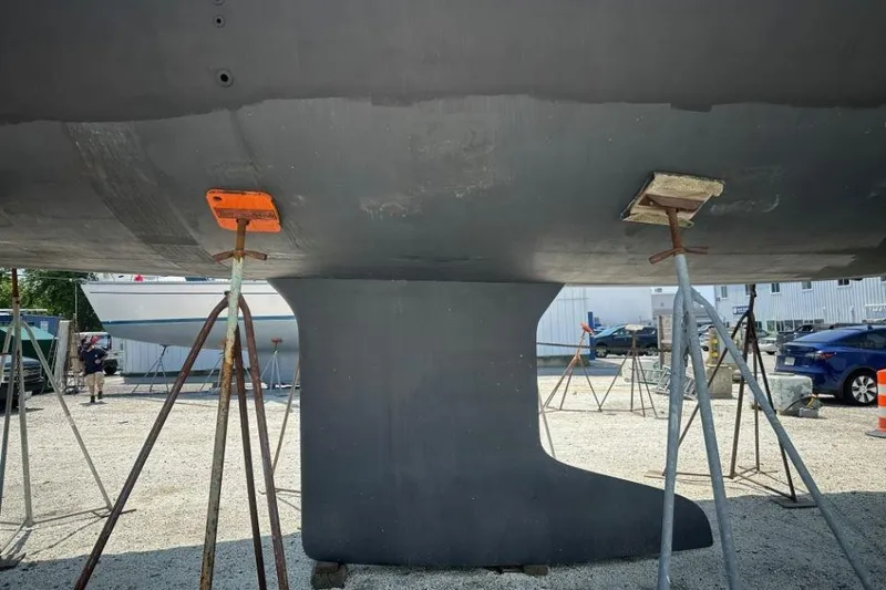 Slide: The Image of Keel of 2019 Moody 54 DS sailboat supported by stands in a boatyard. - 7