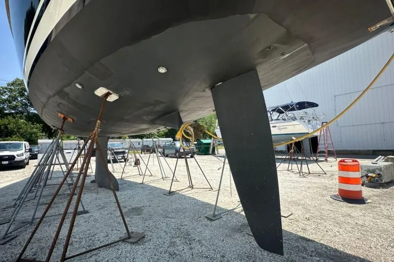Slide: The Image of 2019 Moody 54 DS yacht on stands in a boatyard, showing keel and rudder. - 8