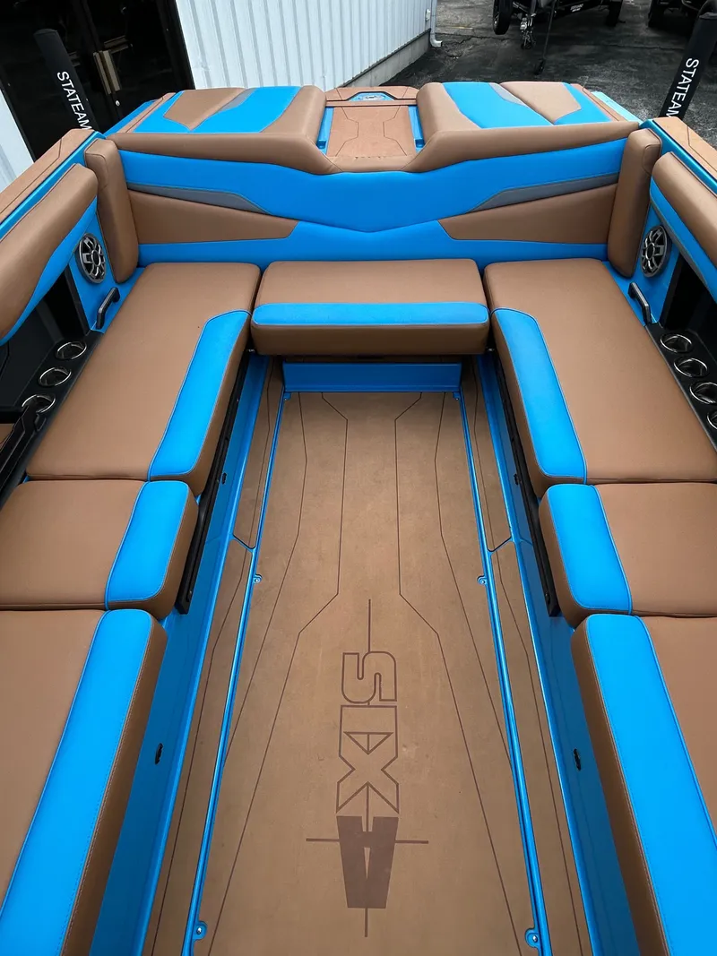 Slide: The Image of Interior of Axis T250 boat, 2023, featuring blue and brown seating. - 10