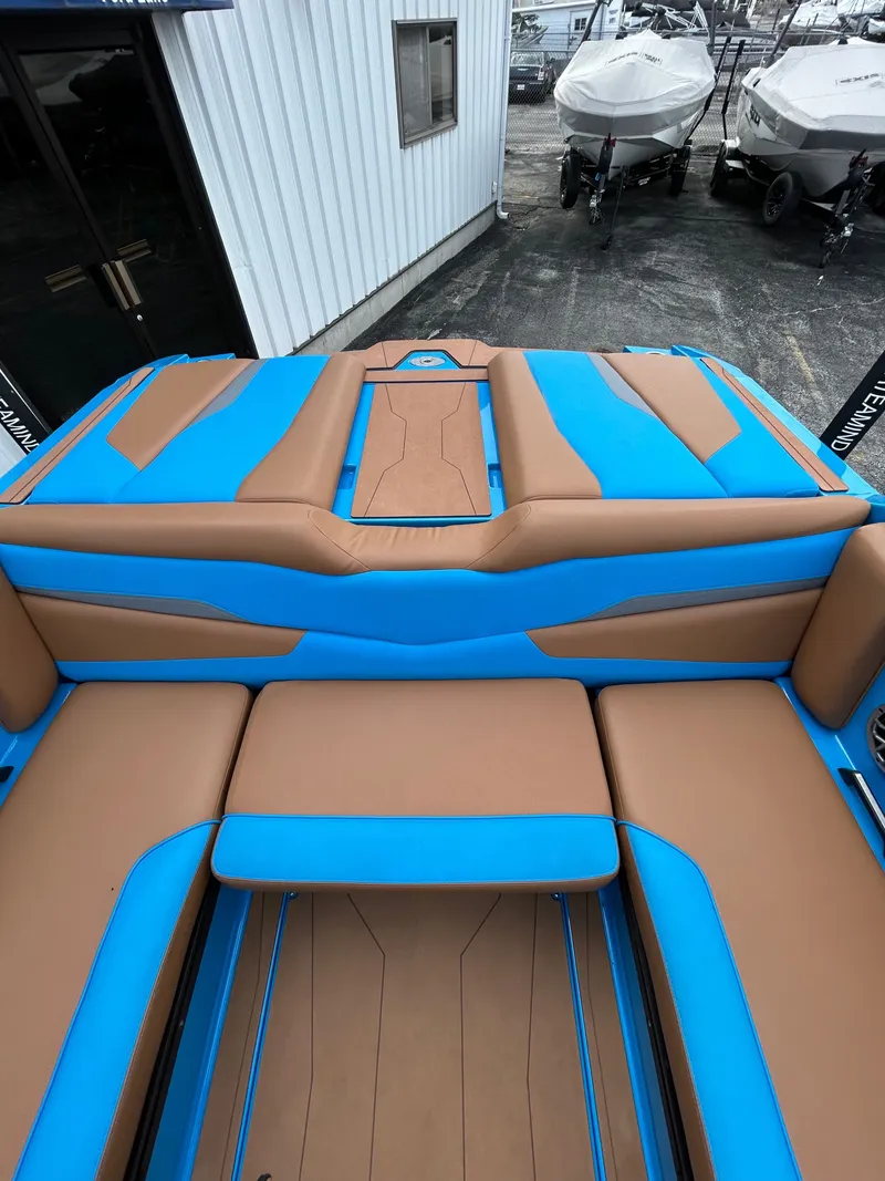 Slide: The Image of Axis T250 2023 boat with blue and brown upholstery. - 11