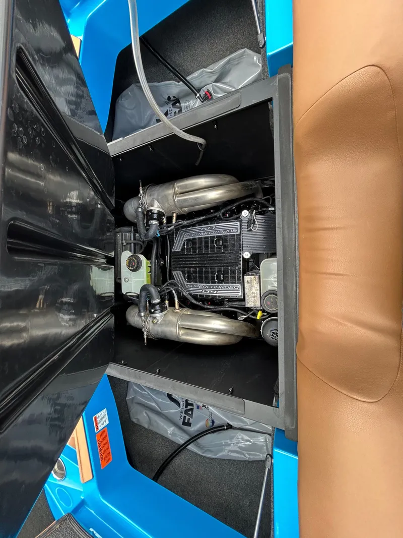 Slide: The Image of Engine compartment of a 2023 Axis T250 boat with open cover. - 12