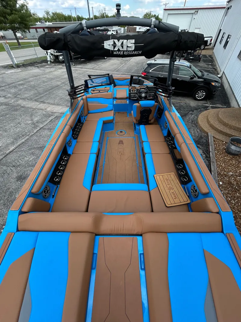 Slide: The Image of 2023 Axis T250 boat with blue and brown upholstery. - 14