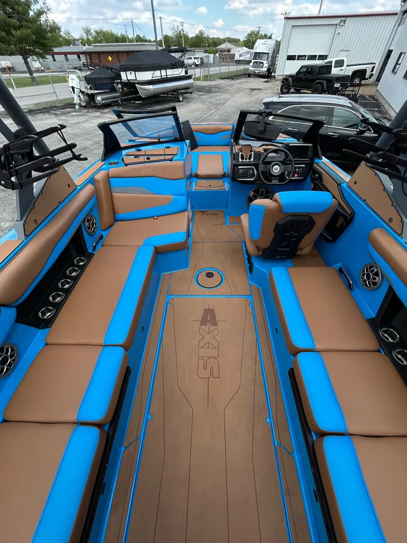Slide: The Image of Interior of a 2023 Axis T250 boat with blue and brown seating. - 15