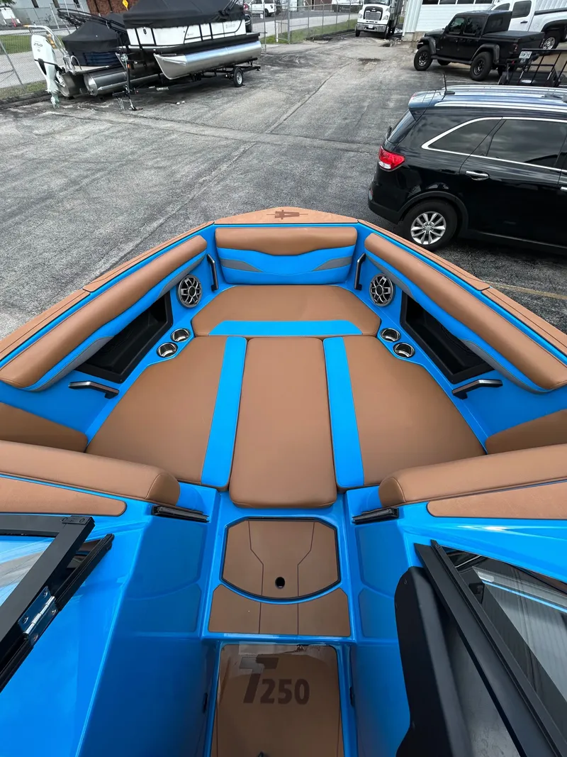 Slide: The Image of 2023 Axis T250 boat with blue and brown upholstery. - 17