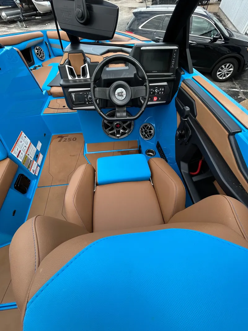 Slide: The Image of Interior of a 2023 Axis T250 boat with blue and brown upholstery. - 19