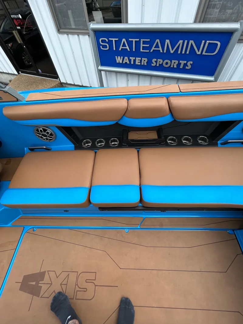 Slide: The Image of Interior of a 2023 Axis T250 boat with brown and blue seating. - 22
