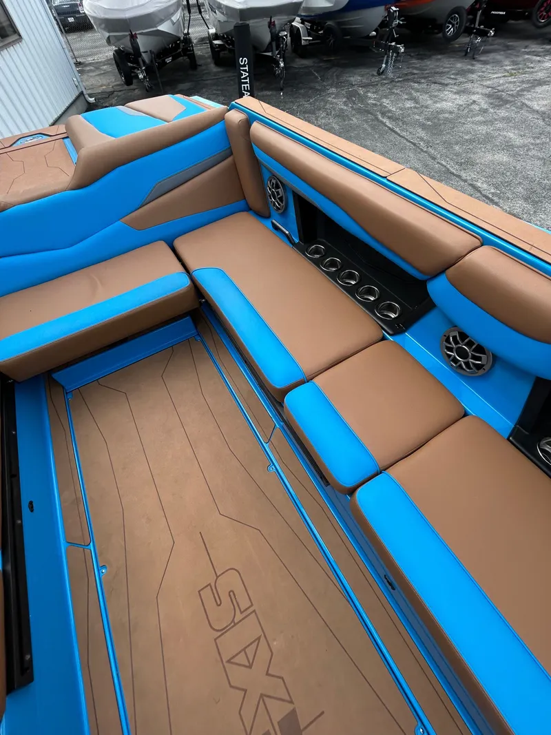 Slide: The Image of Interior of a 2023 Axis T250 boat with blue and brown seating. - 24