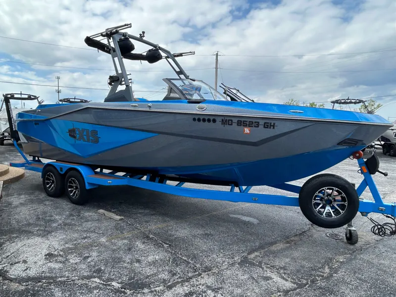Slide: The Image of 2023 Axis T250 boat on blue trailer, gray and blue paint. - 5