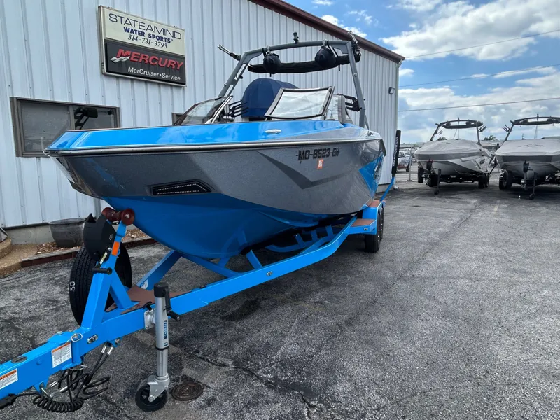 Slide: The Image of 2023 Axis T250 boat on blue trailer outside a building. - 7