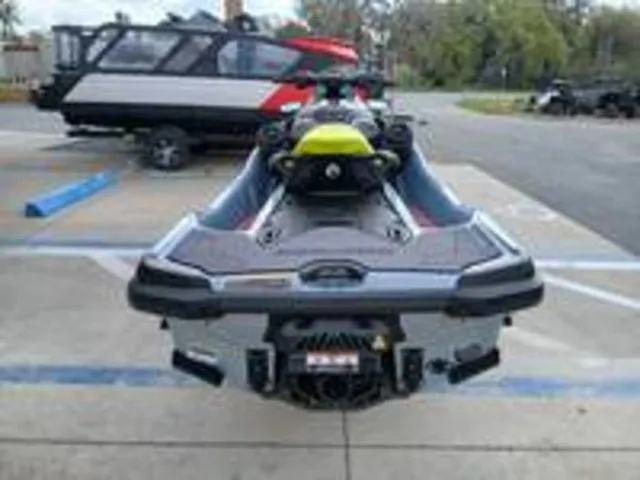 Slide: The Image of Rear view of a 2026 Sea-Doo RXT-X jet ski in a parking lot. - 10
