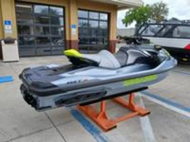 Slide: The Image of 2026 Sea-Doo RXT-X jet ski on a stand outside a building. - 12