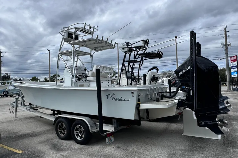 Slide: The Image of 2021 Pair Customs 24 Center Console MV boat on trailer, featuring Mercury outboard motor. - 0