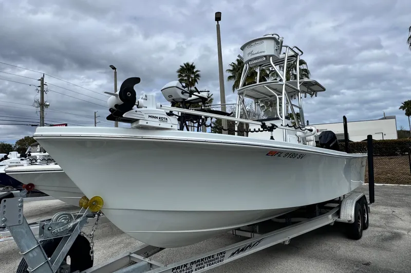 Slide: The Image of 2021 Pair Customs 24 Center Console MV boat on trailer, featuring Minn Kota trolling motor. - 1