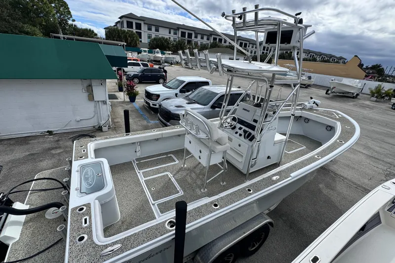 Slide: The Image of 2021 Pair Customs 24 Center Console MV boat in parking lot, featuring elevated helm station. - 3