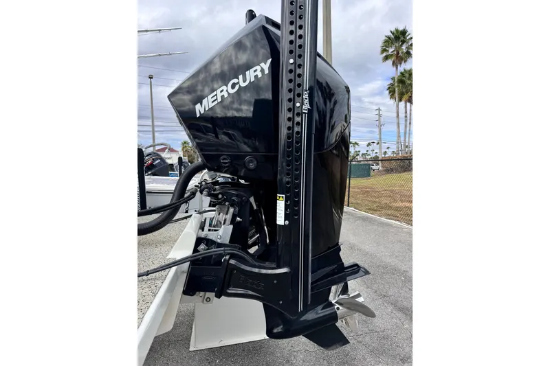 Slide: The Image of 2021 Pair Customs 24 Center Console MV with Mercury outboard motor, parked outdoors. - 6