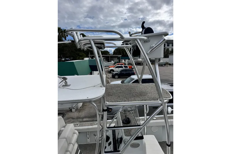 Slide: The Image of 2021 Pair Customs 24 Center Console MV with elevated helm station, parked outdoors. - 7
