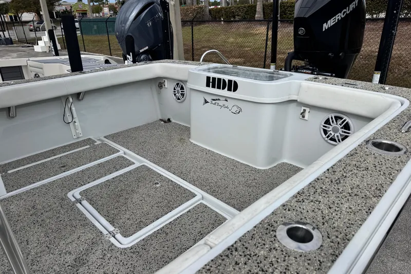 Slide: The Image of 2021 Pair Customs 24 Center Console MV boat interior with fishing rod holders and speakers. - 8