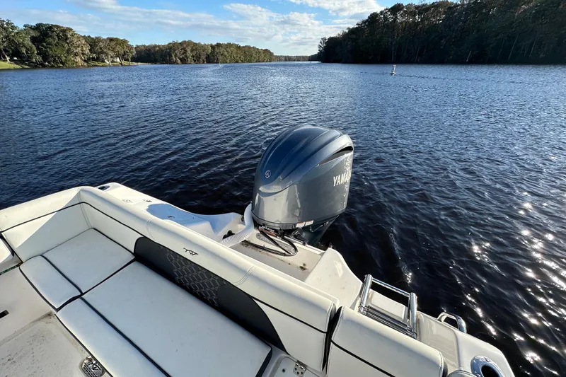 Slide: The Image of 2023 Tidewater 232 LXF boat with Yamaha engine on a serene lake. - 11